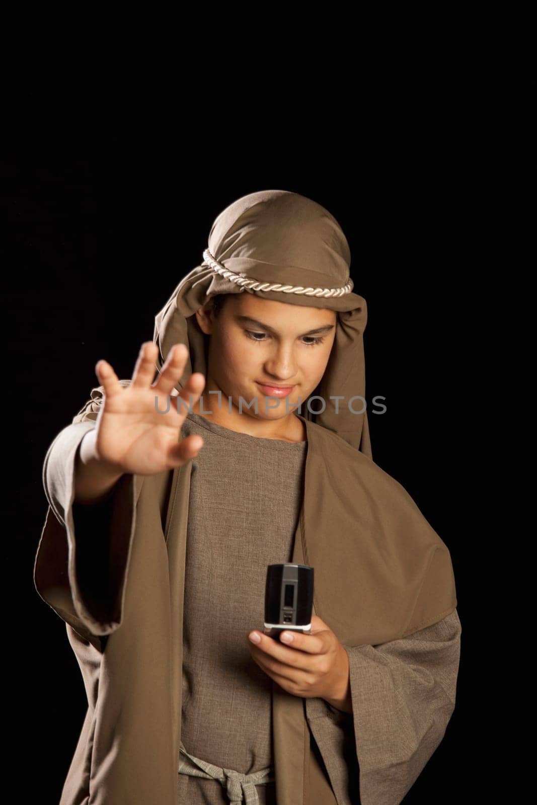 boy depicting jesus holding a cellphone