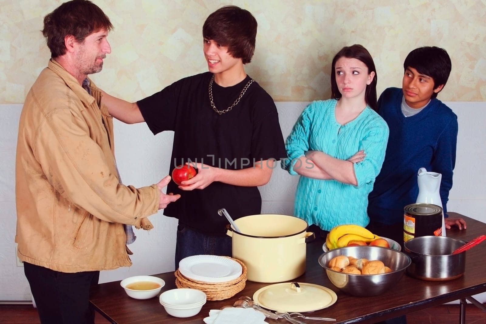 teenagers serving a meal to a man