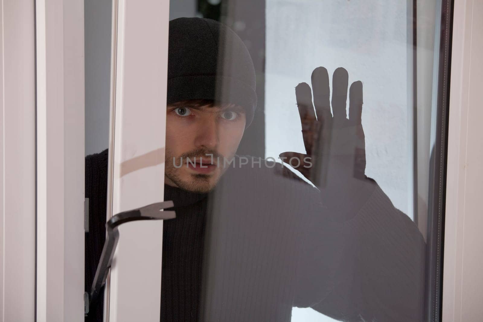 burglar looking into glass window