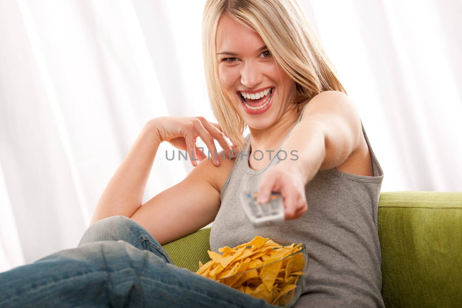 Student - young blond woman watch TV