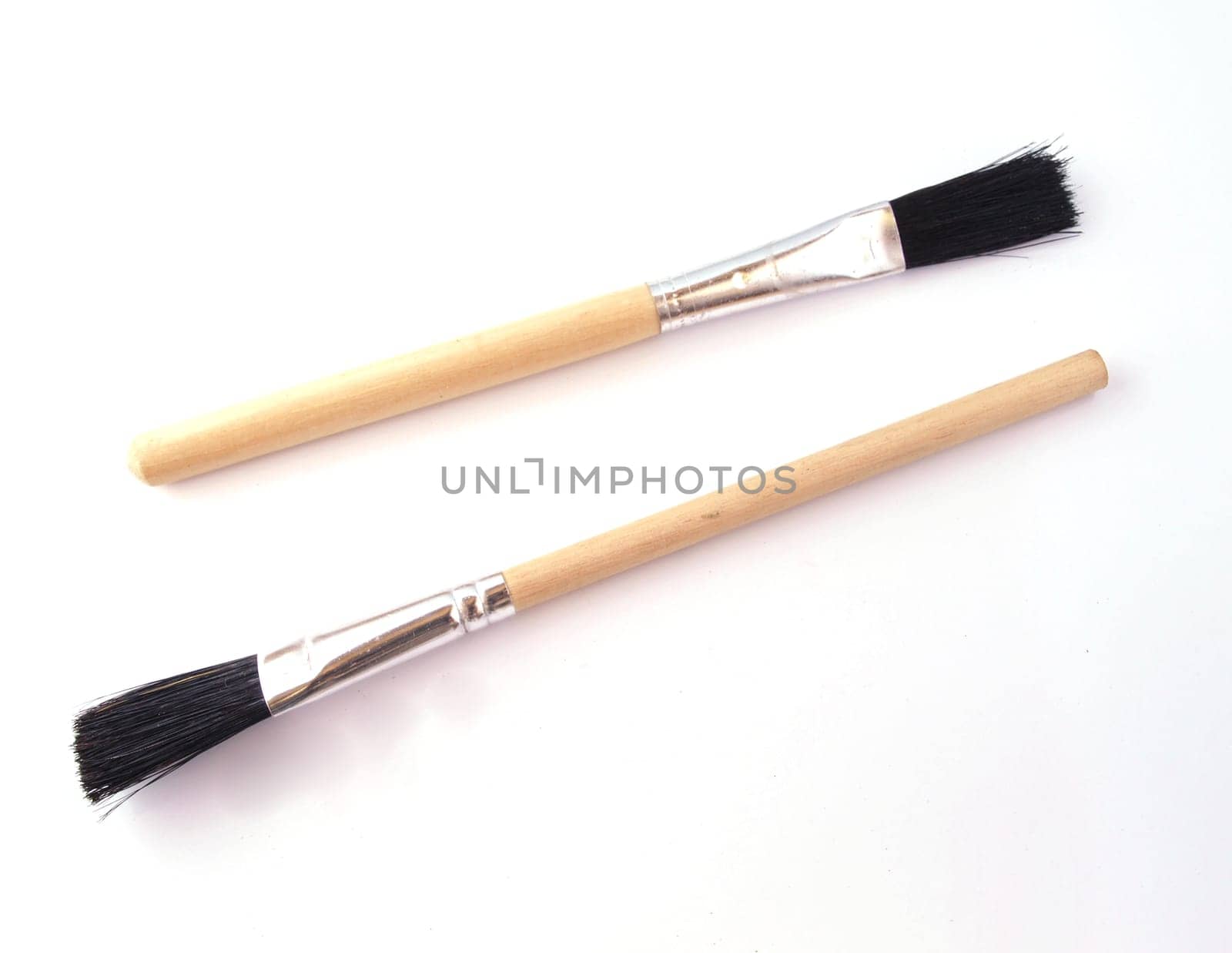 Two new paint brushes on a white background.