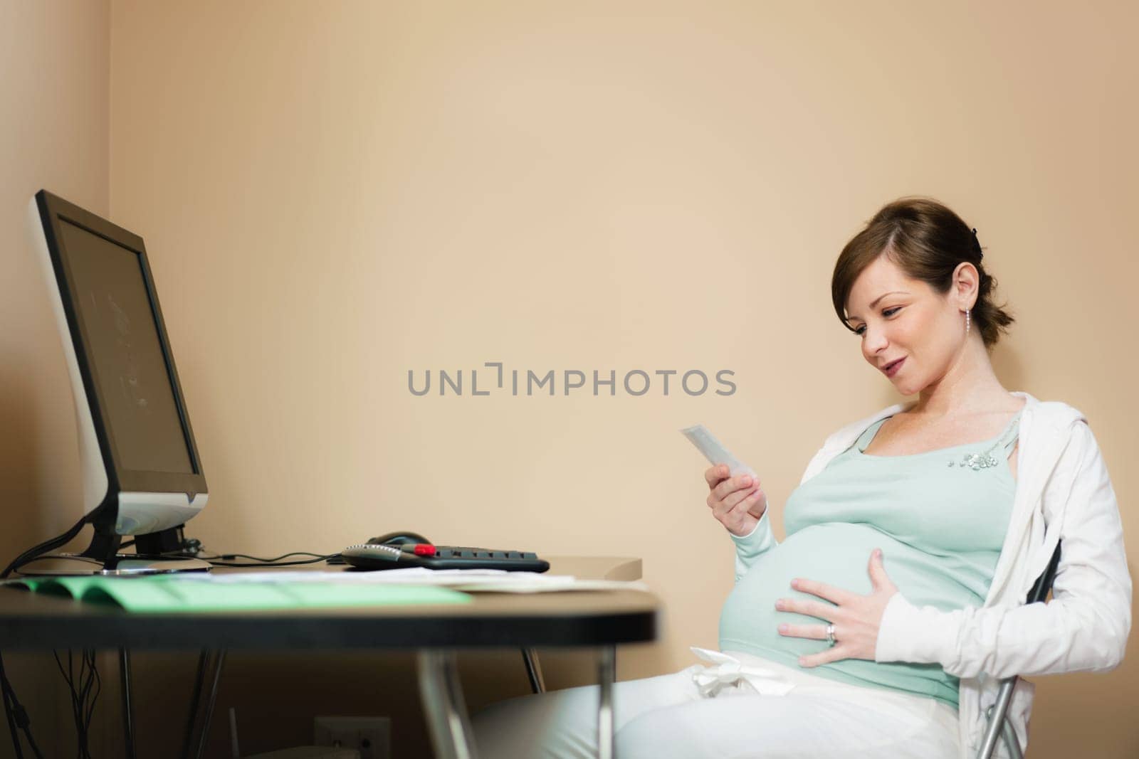 pregnant woman looking at scans