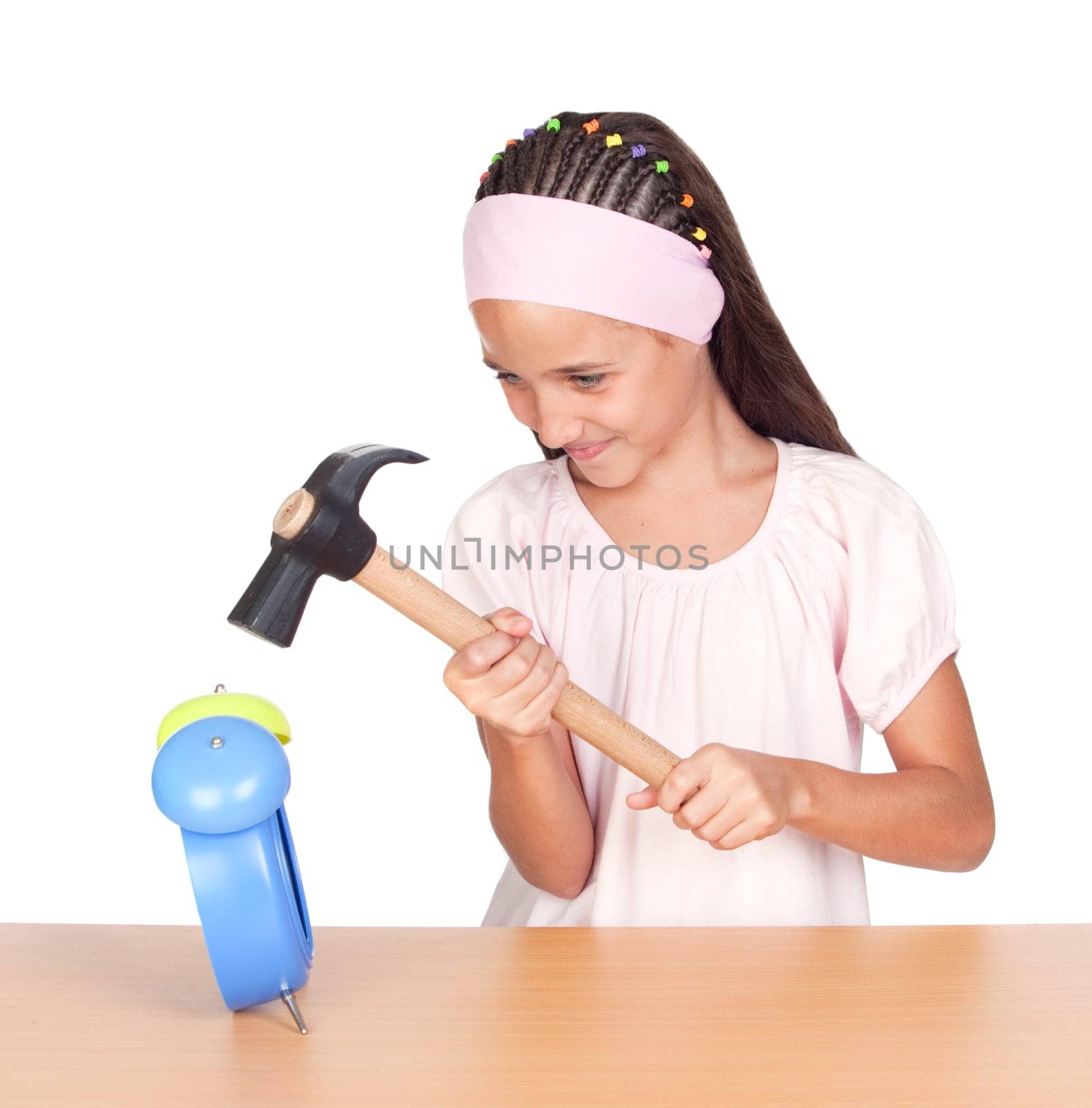 Little girl breaking an alarm clock
