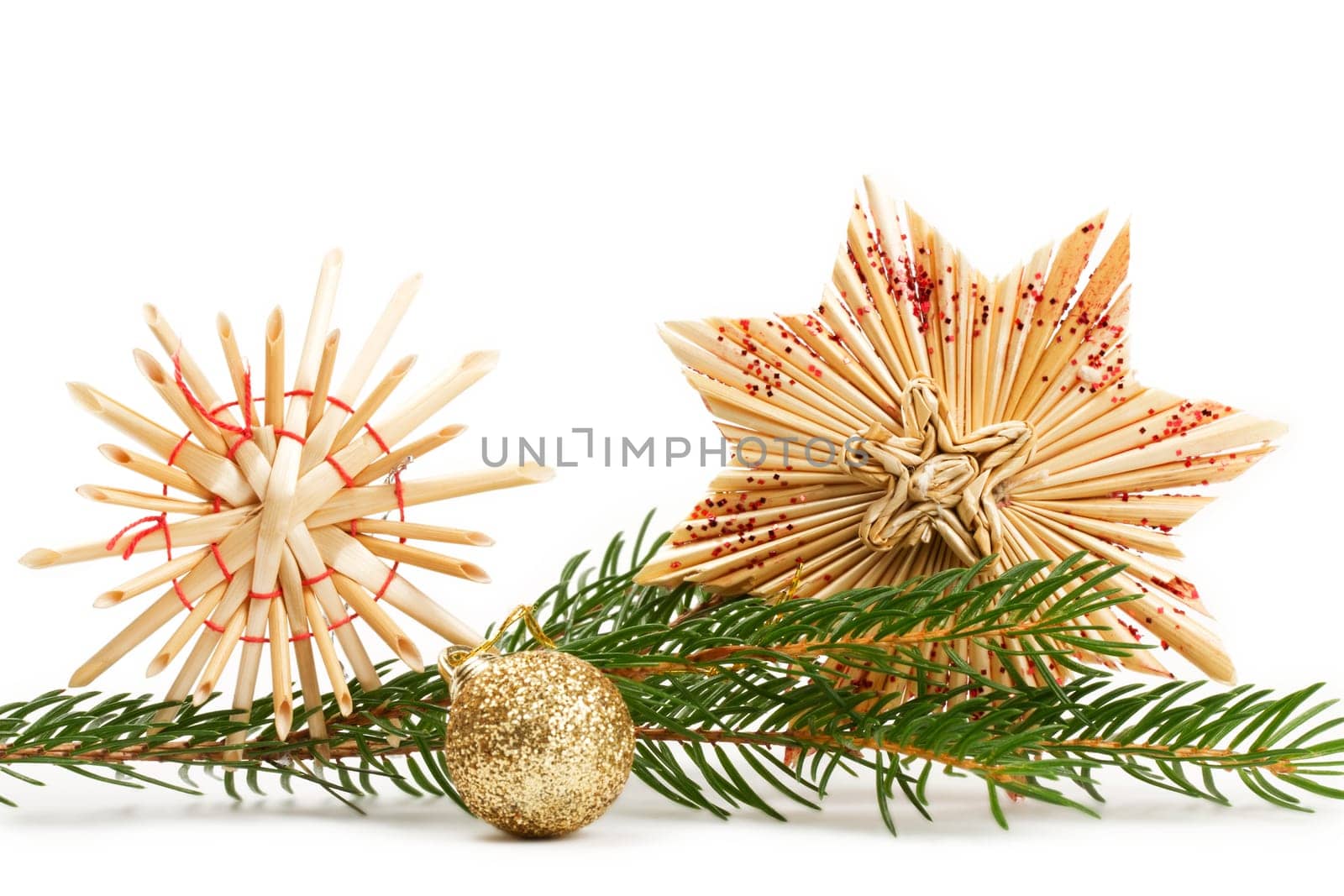 Two straw stars and fir branch