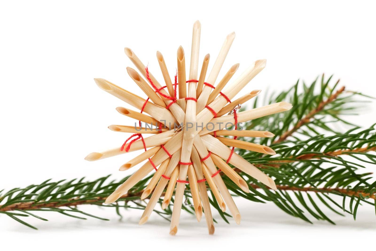 Straw star in front of fir branch