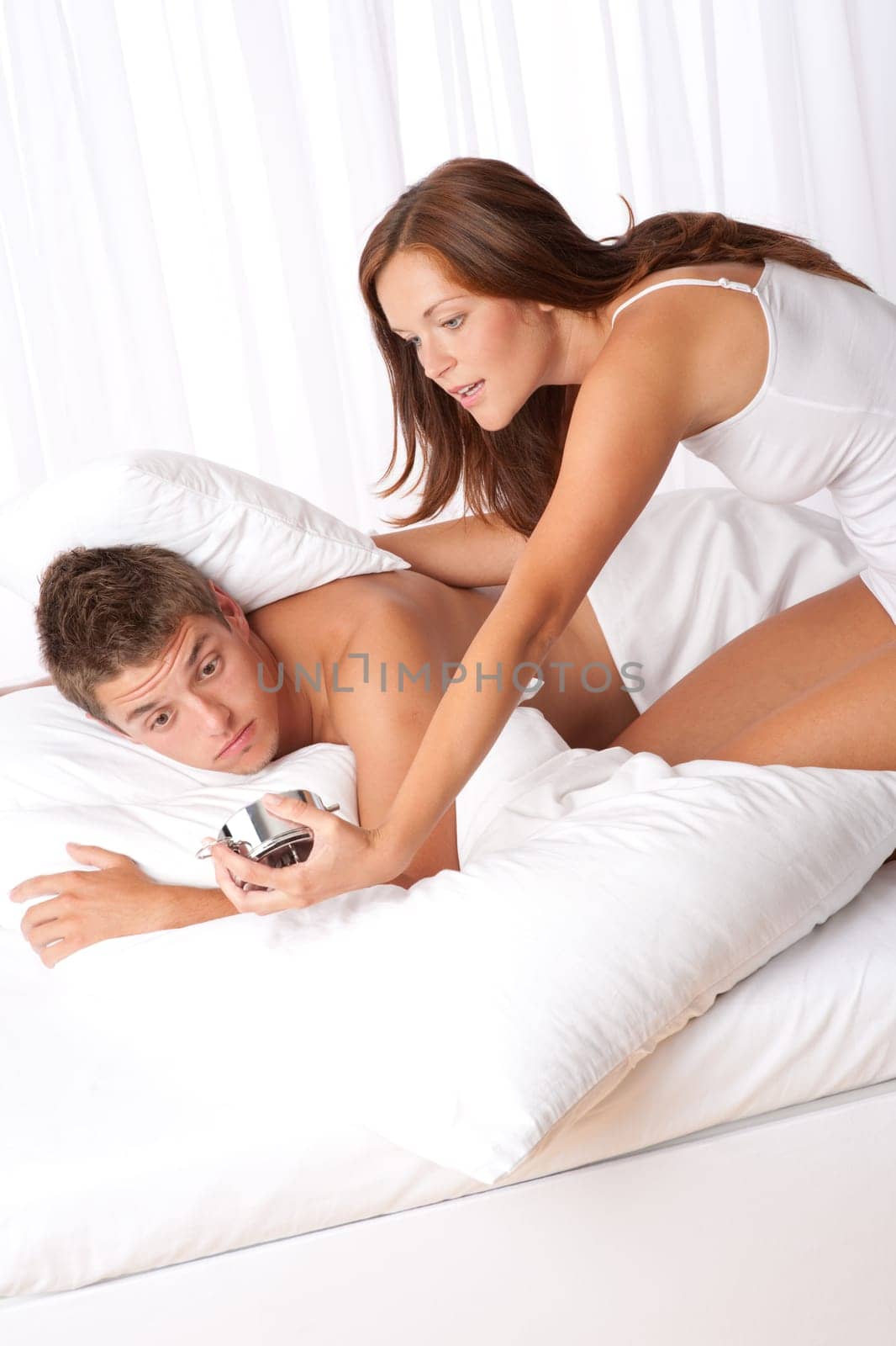 Young couple overslept, wake up in bed