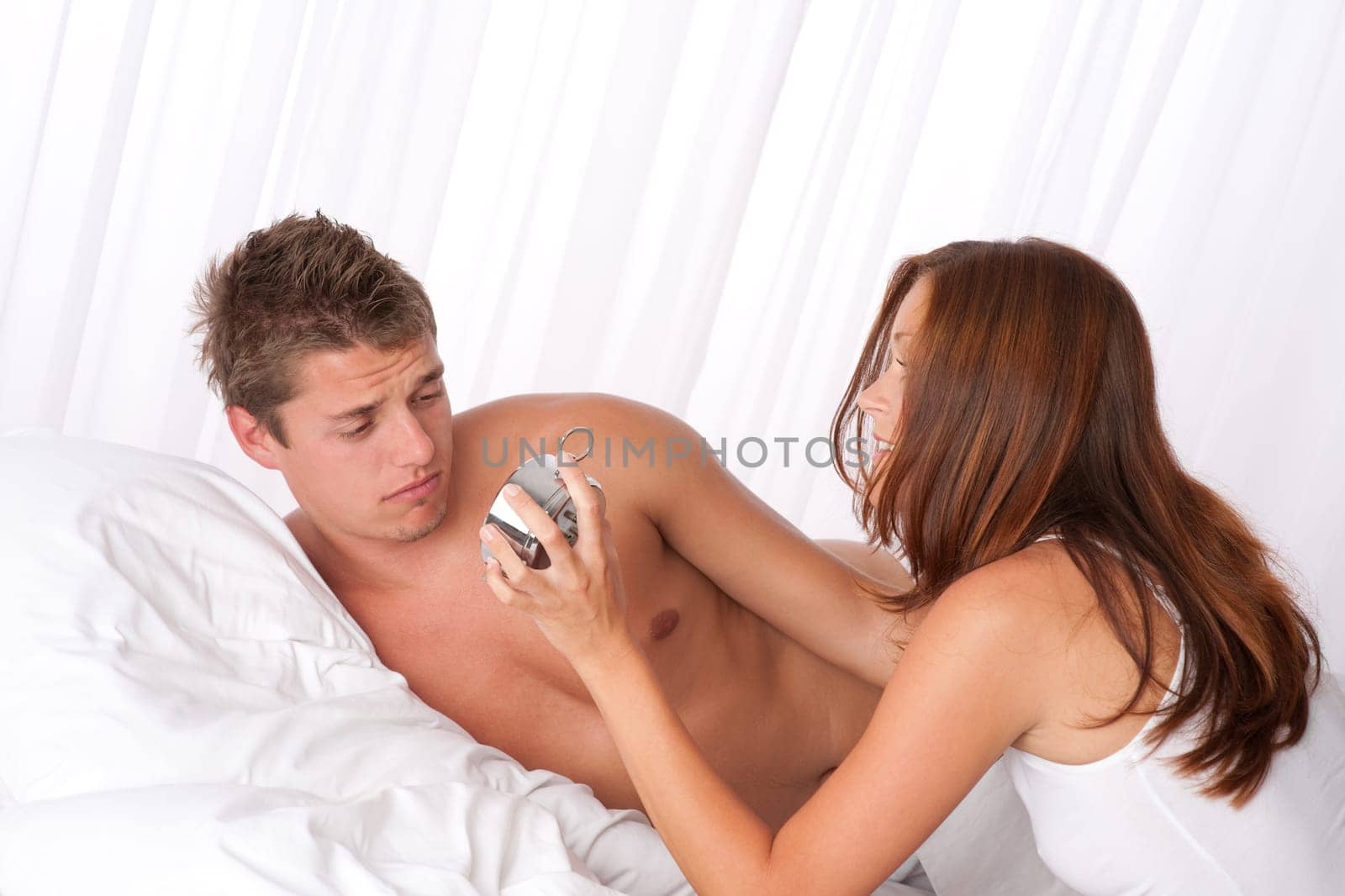 Young couple overslept, wake up in bed