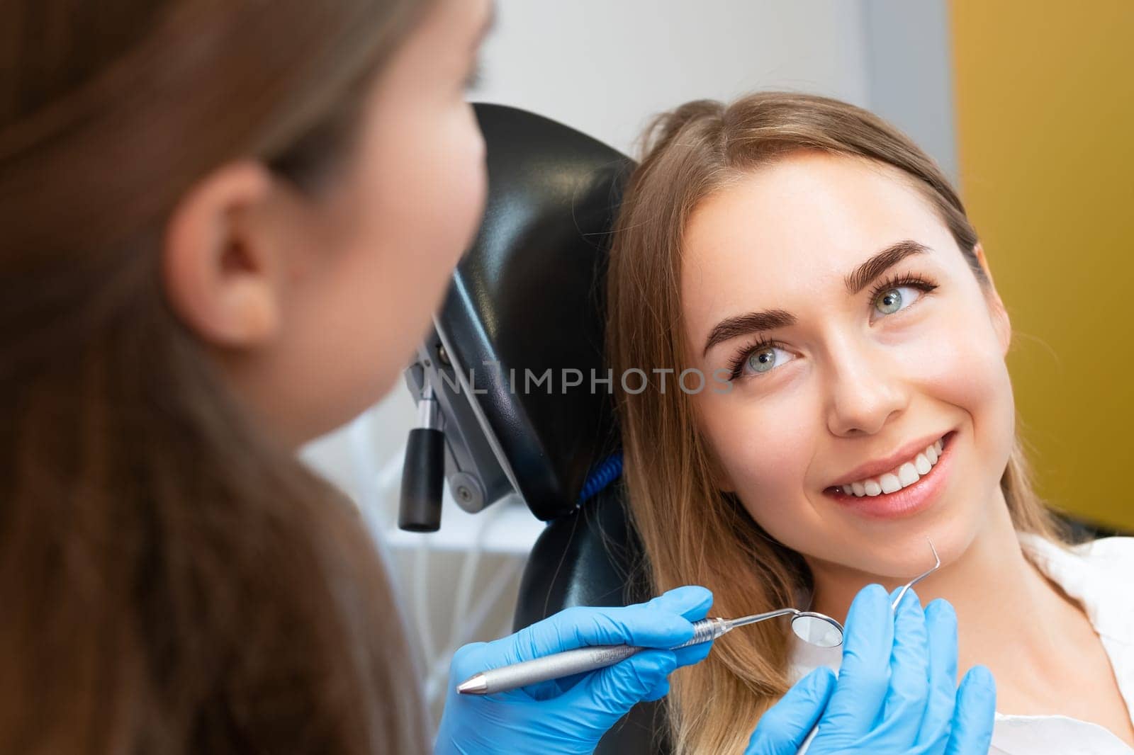 Young beautiful female patient with green eyes before dental treatment by vladimka