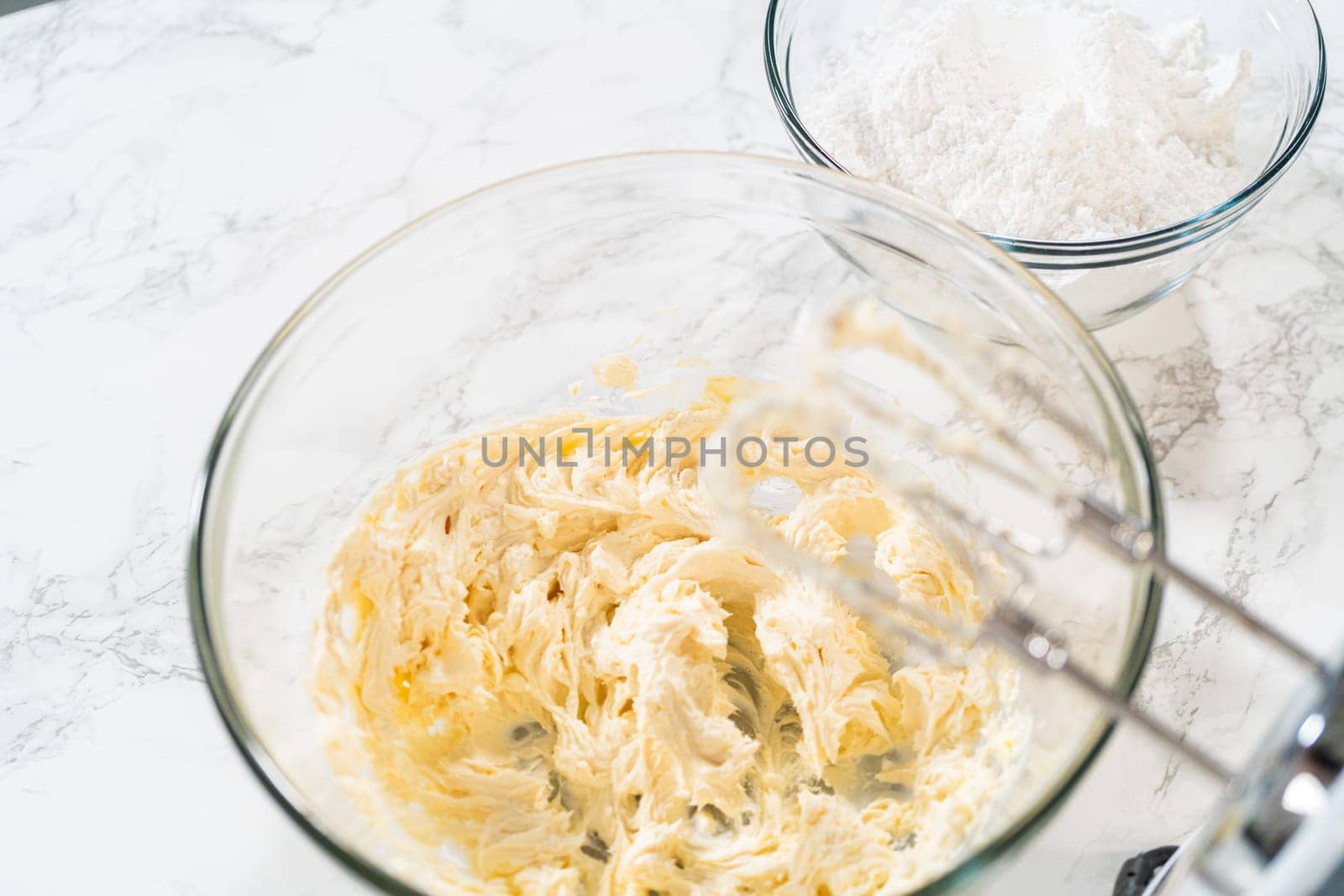 Creating a delectable treat, the process of making homemade cream cheese frosting involves whisking together creamy ingredients to achieve the perfect texture and taste.