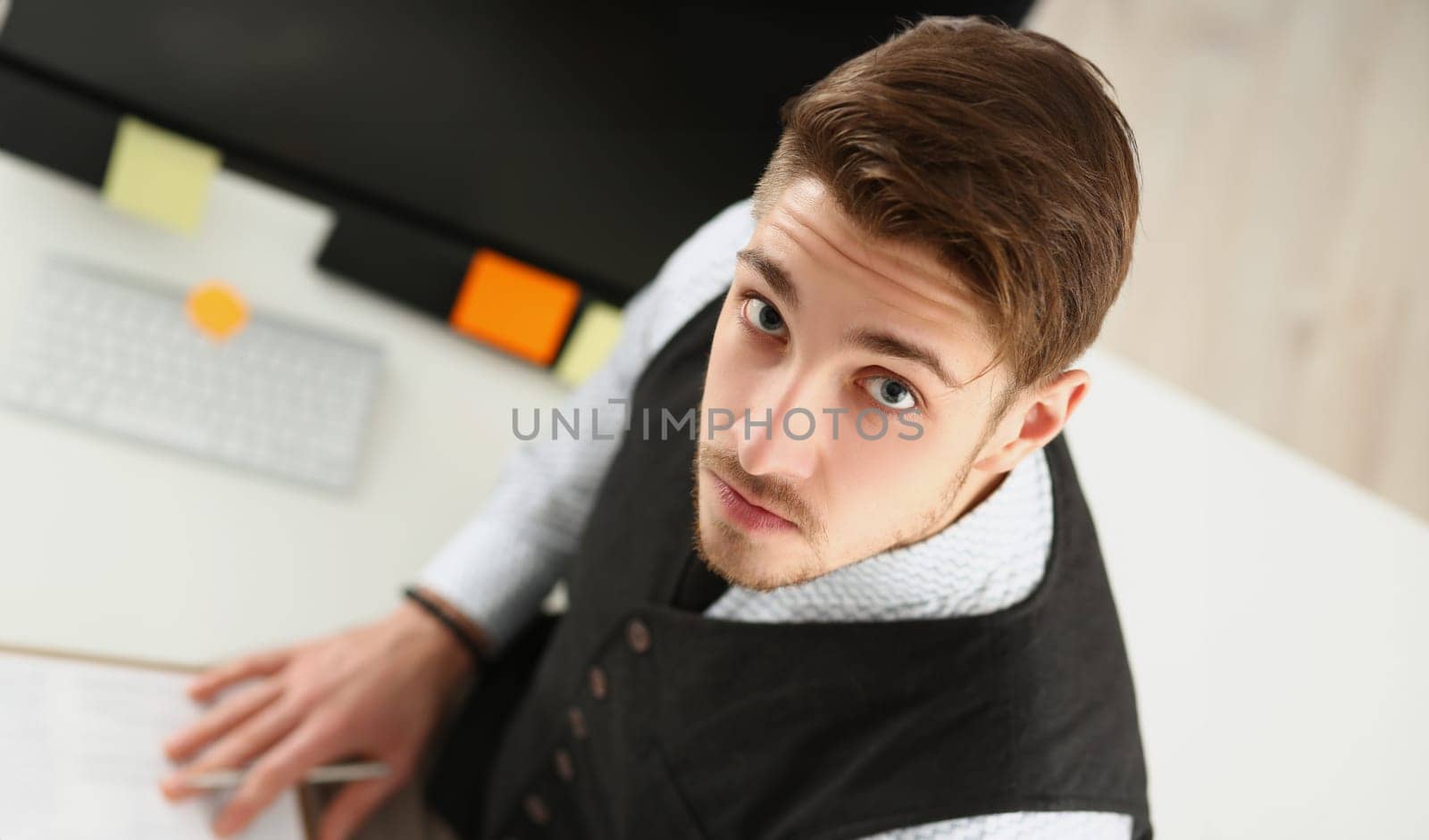Top view of man look up, make notes on paper, employee in suit at working place. Clerk, secretary, office life, planning, career, manager, business concept