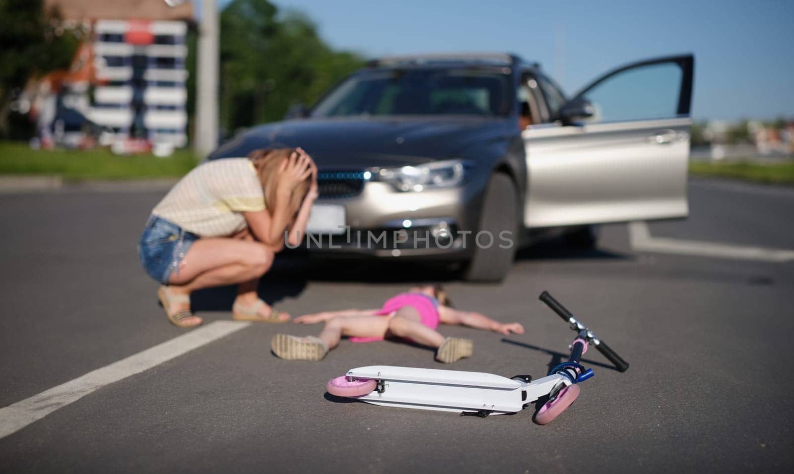 Portrait of girl with scooter hit on road by car, eyewitness worry for child, road accident. Automobile driver hit child. Accident, violation concept