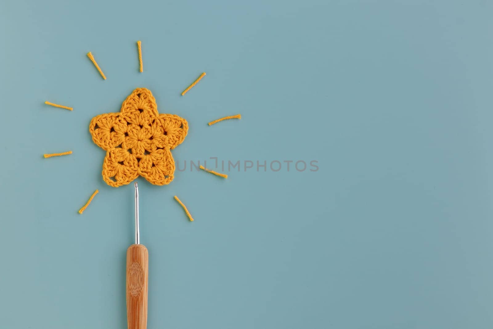 The  crocheted star on a bright background with copy space / pattern by Gudzar