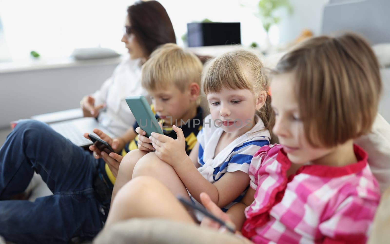 Children at home, stare at smartphone screens, addiction to modern technologies by kuprevich
