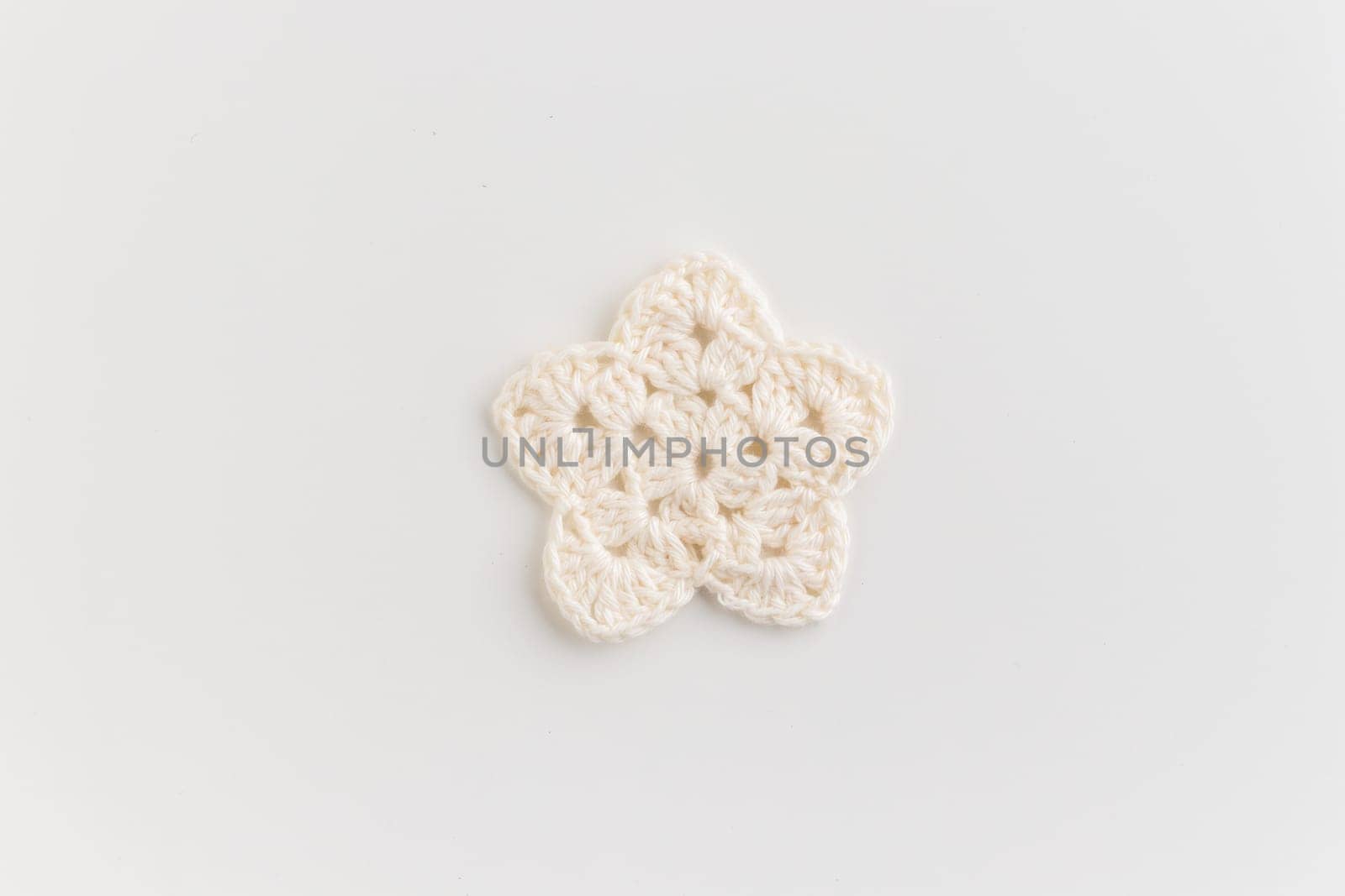 The white crocheted star pattern on a white background