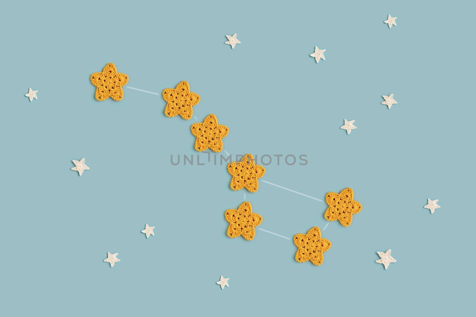 Yellow crocheted stars - constellation Ursa Major - on a blue background