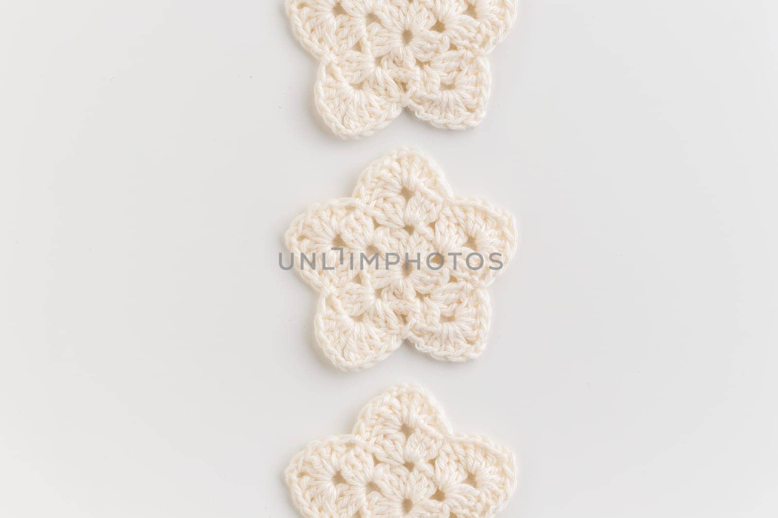 White crocheted stars row pattern on a white background