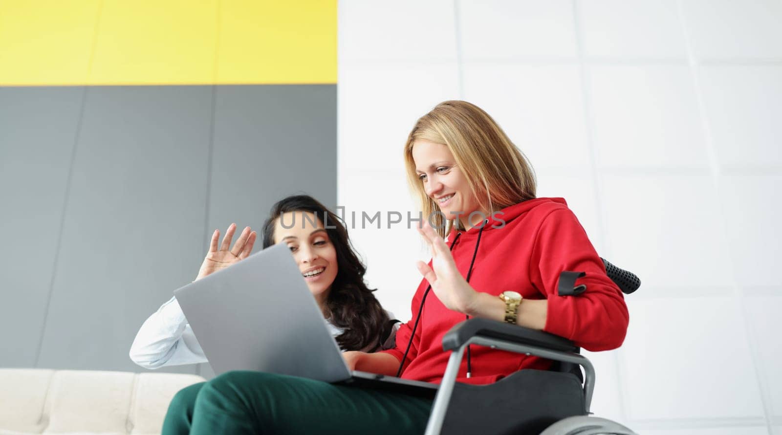 Portrait of women greeting family via online video call using laptop, woman visit friend in wheelchair at nursing home. Bff, meeting, happiness concept
