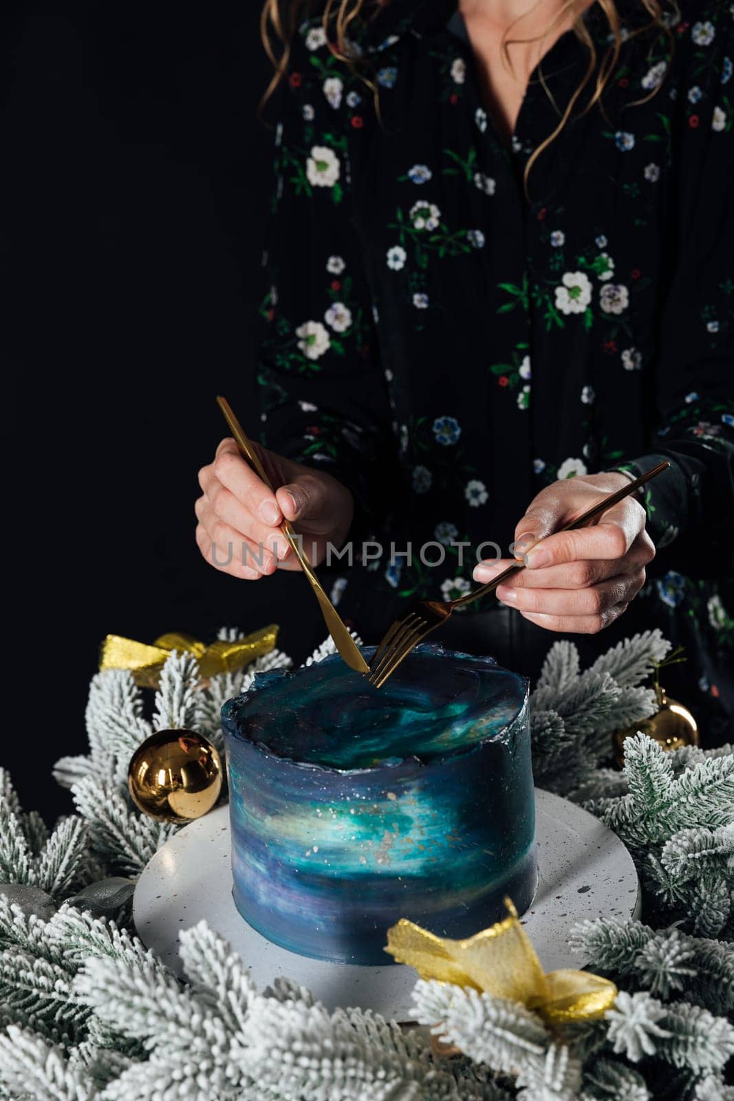 woman cuts a cake for a holiday pastry chef