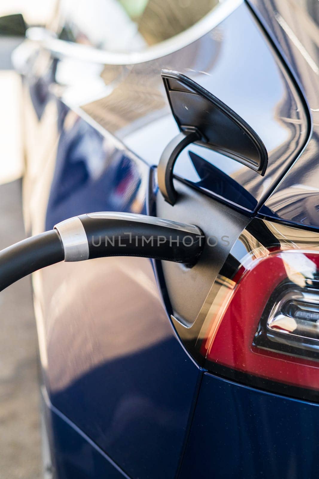 Baker, California, USA-October 12, 2021 - Tesla supercharging station during the day.