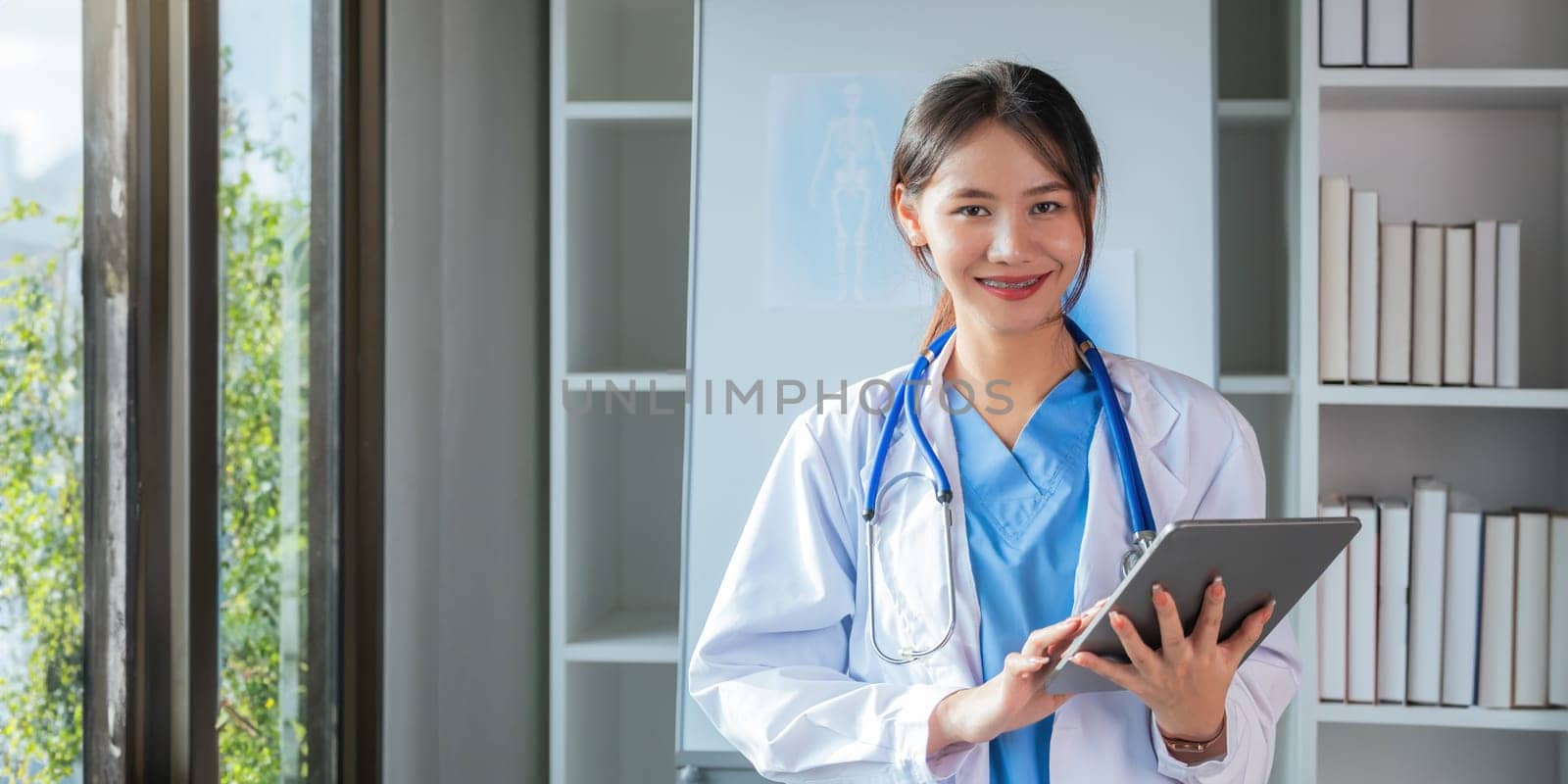 Portrait medical concept of Asian beautiful female doctor in white coat with stethoscope, waist up. medical by nateemee