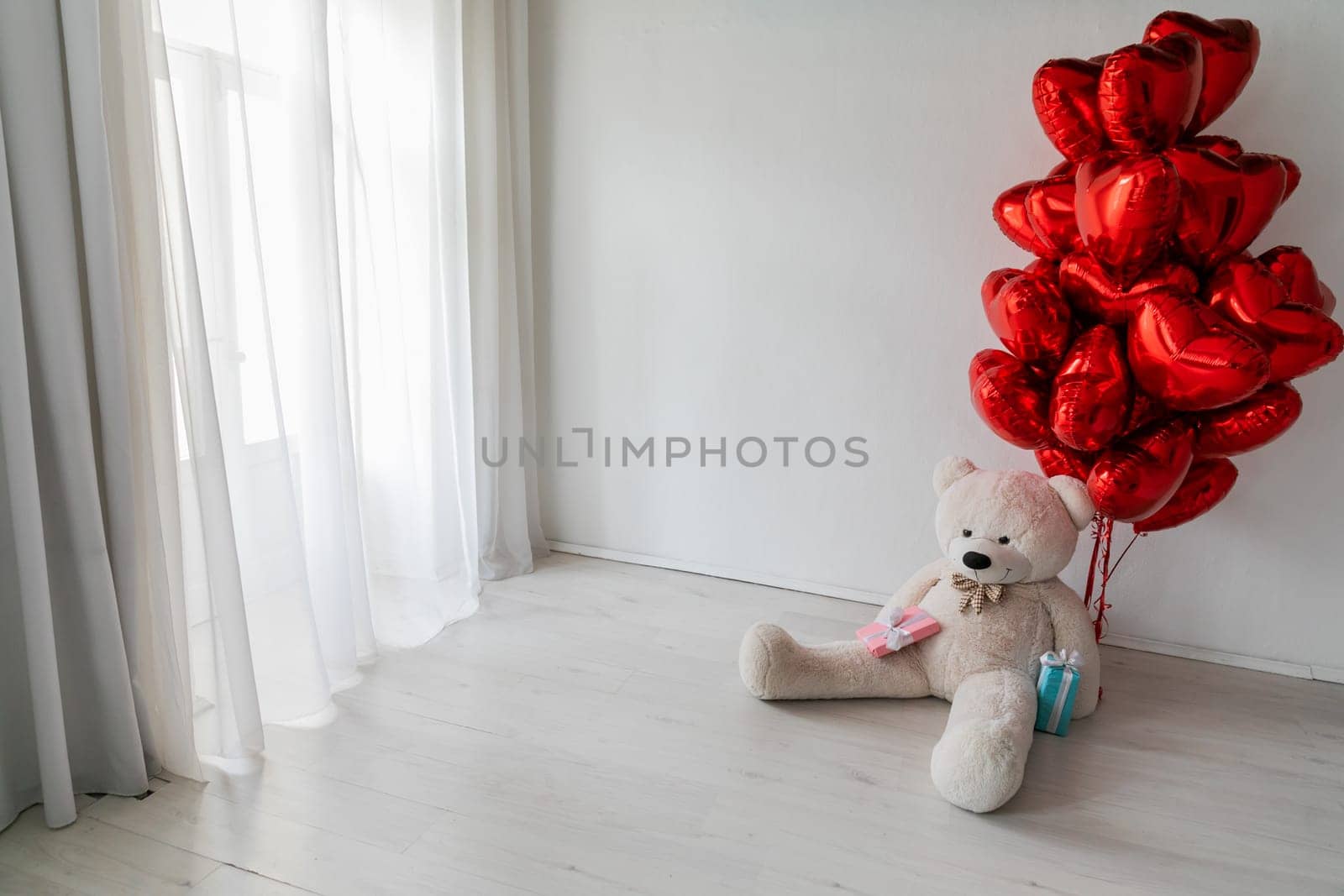 an Interior red balloons with soft toy and gifts