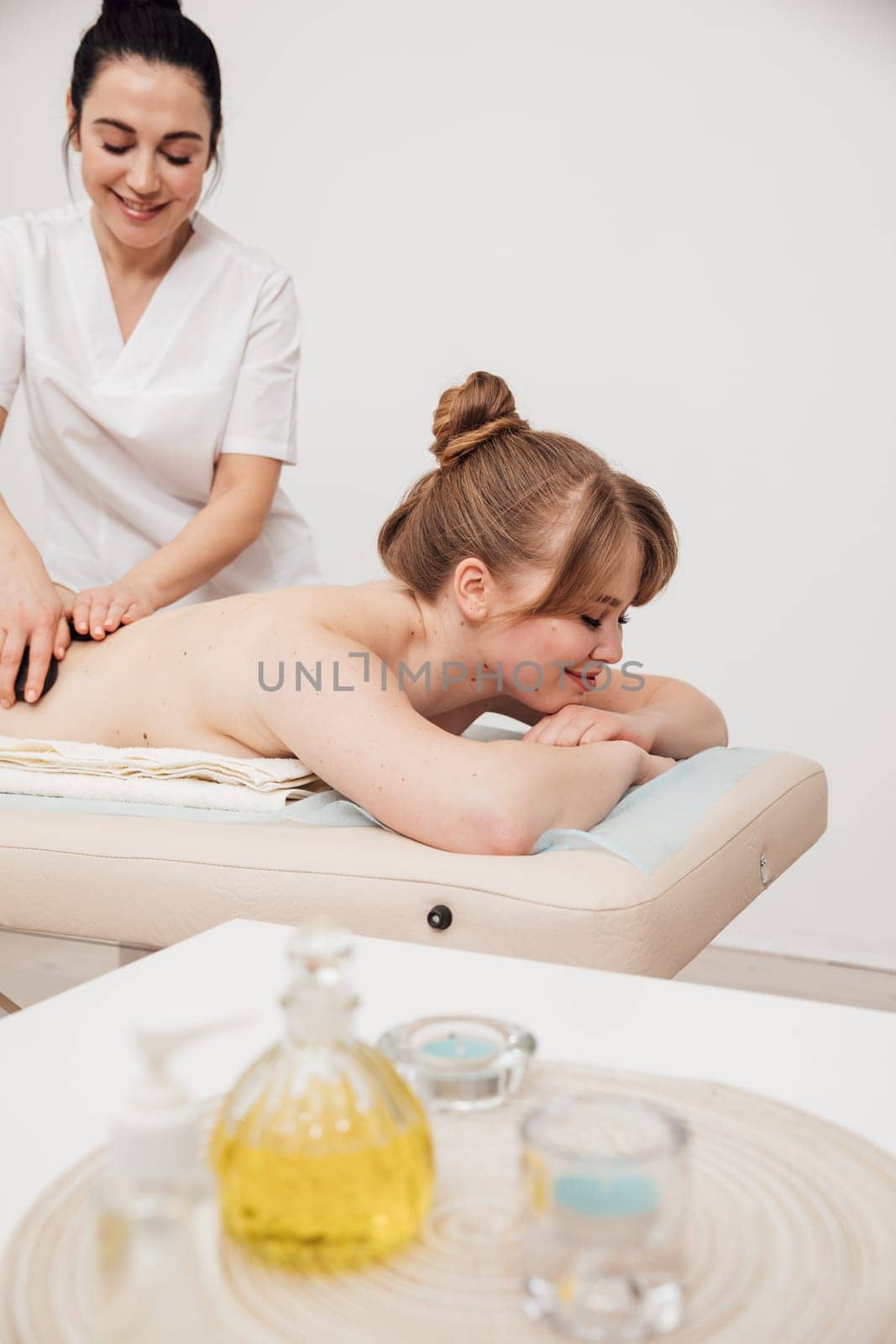 a relax spa back massage with stones in the massage room