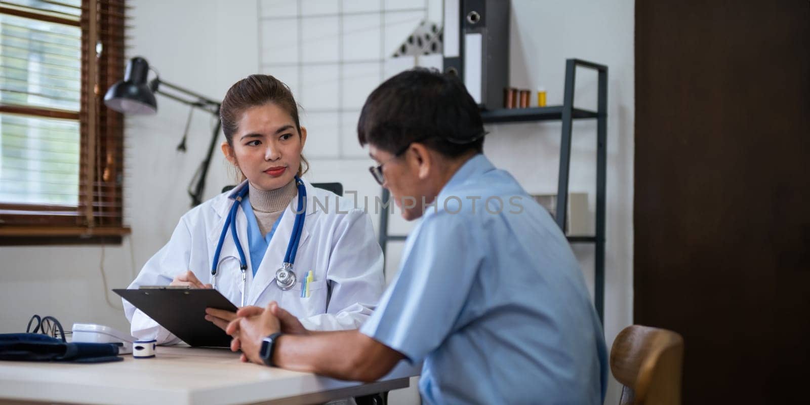 doctor discussion results or symptoms and gives a recommendation to a senior male patient, giving consultation during medical examination in clinic.