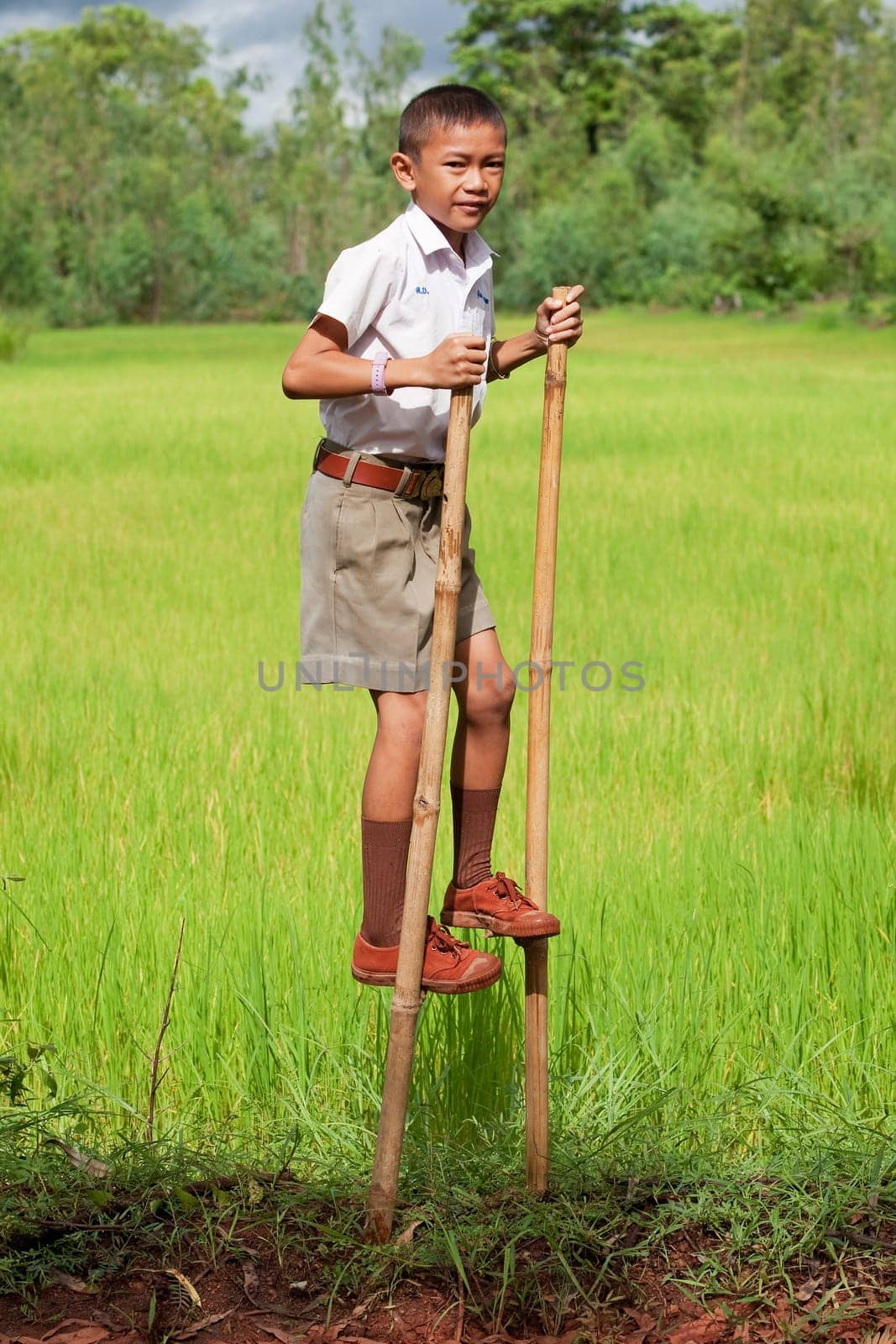 Boy walks on stilts
