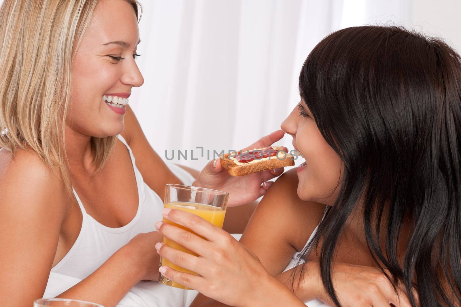 Lesbian female couple having breakfast