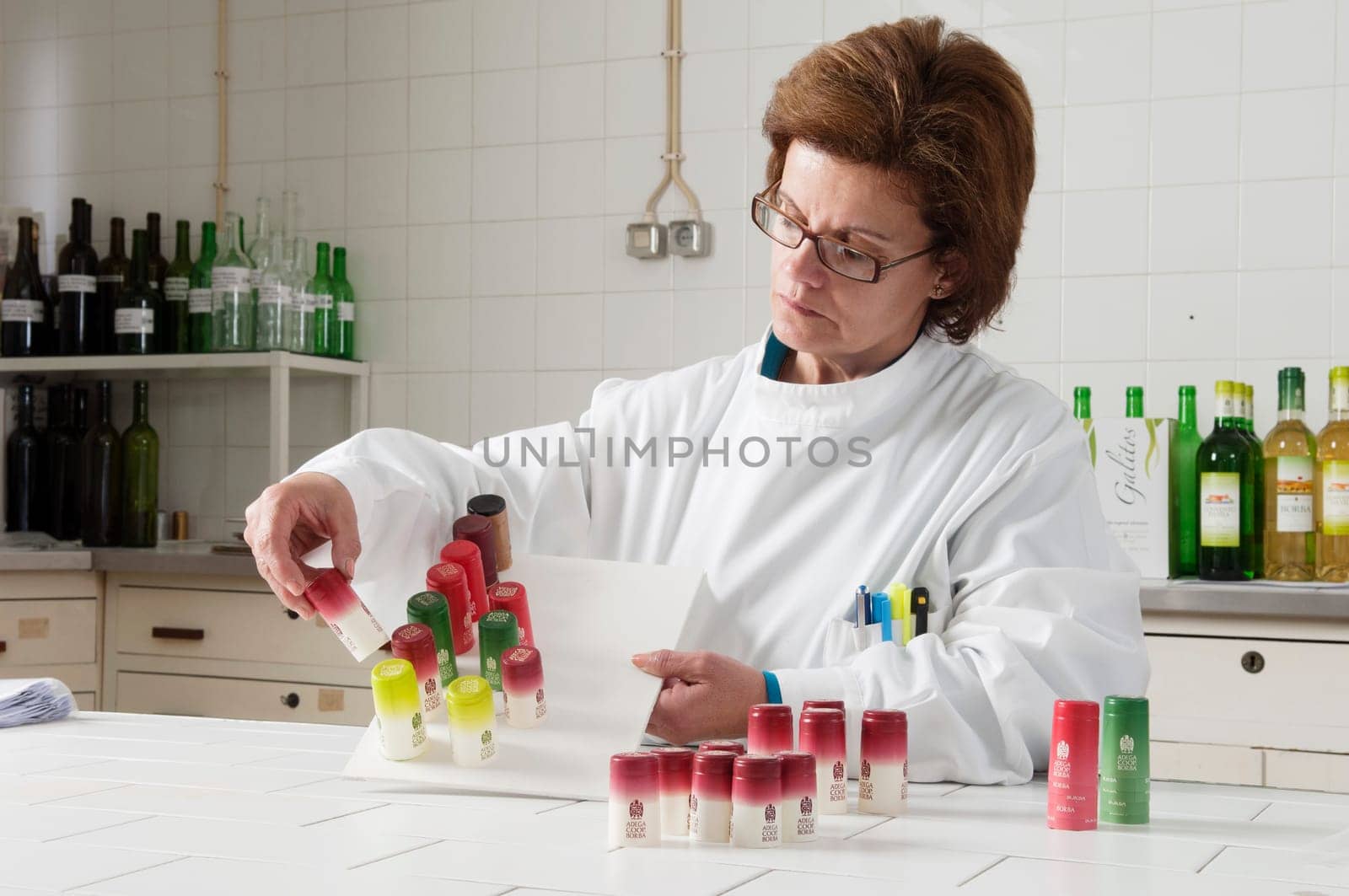Woman checking bottle capsules