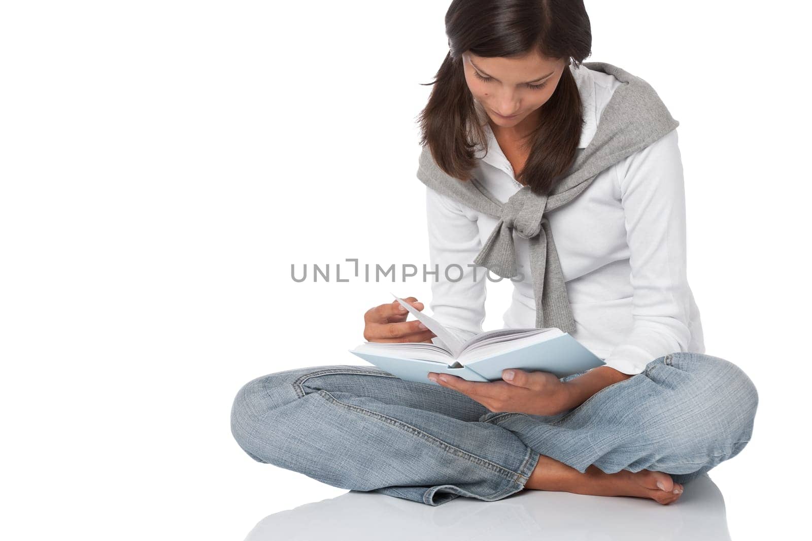 Attractive happy teenager reading book