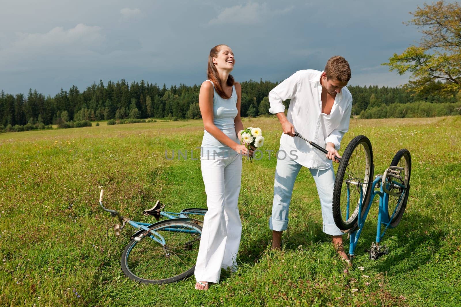 Summer - romantic couple with old-fashioned bike in nature