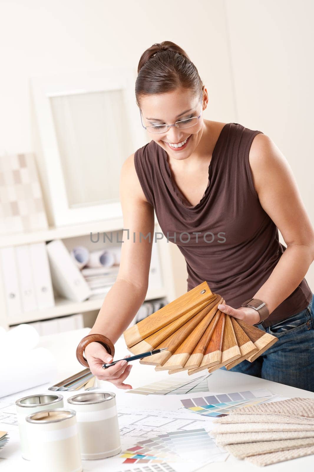 Young female designer with wooden color swatches