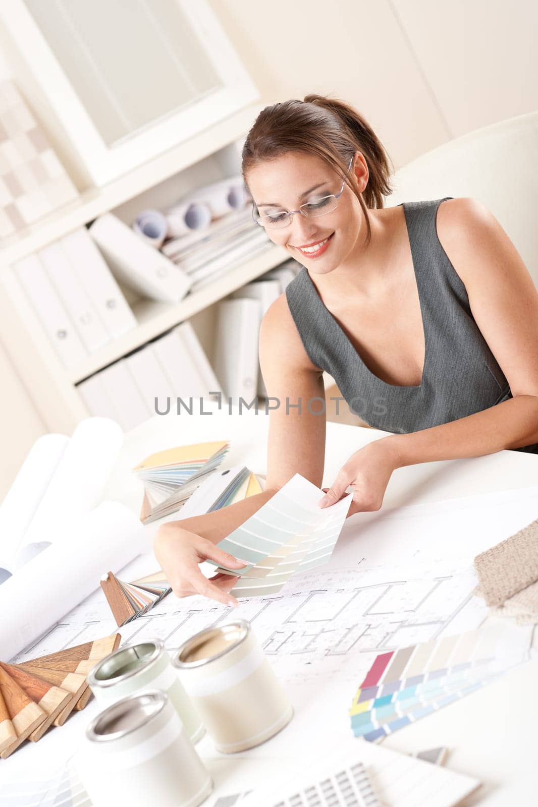Female interior designer working with color swatch