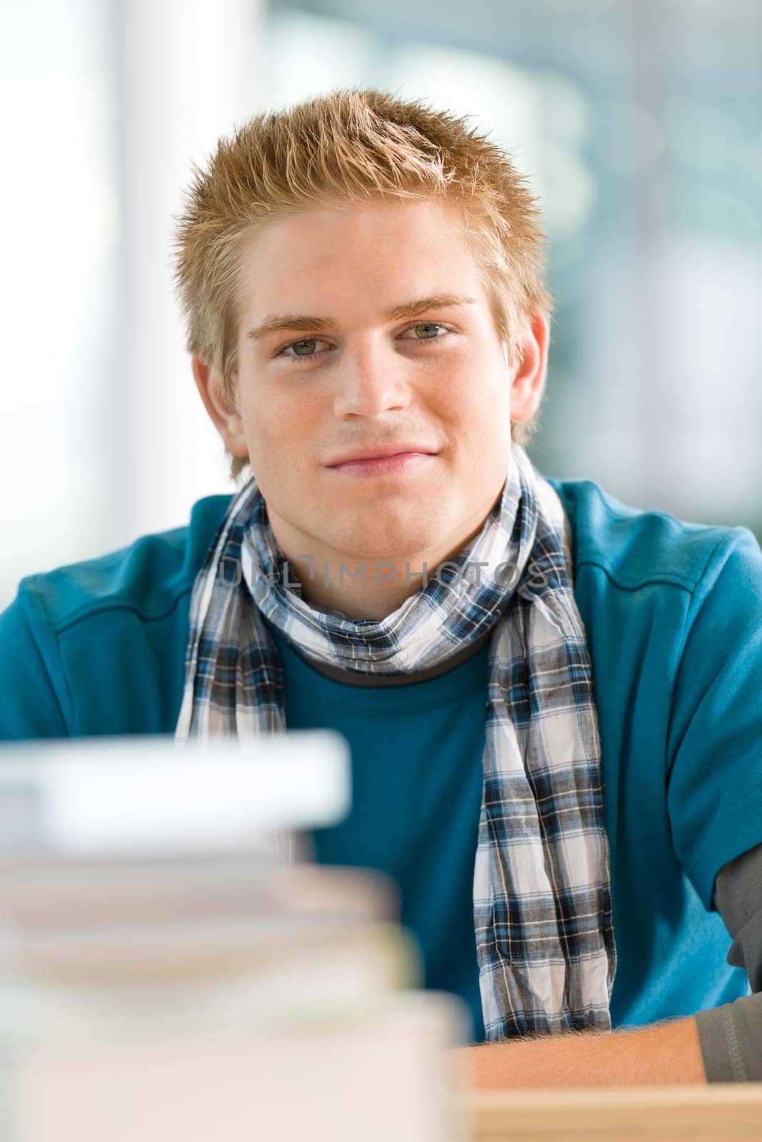 Portrait of male student with books