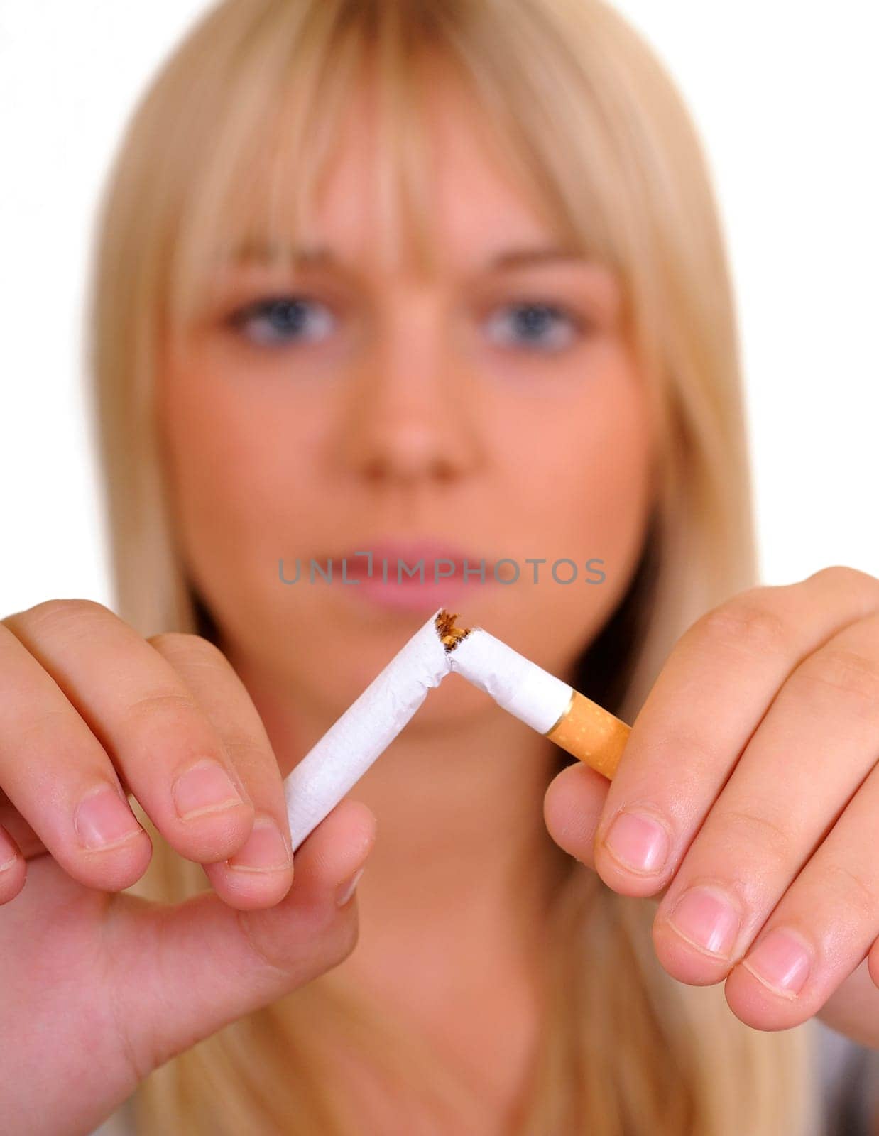 Young woman breaking a cigarette