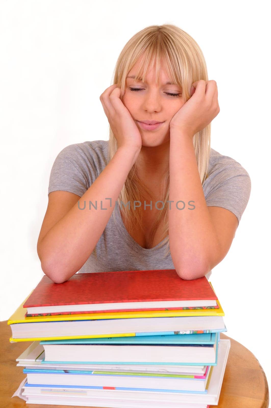 Woman sleeping on a pile of books