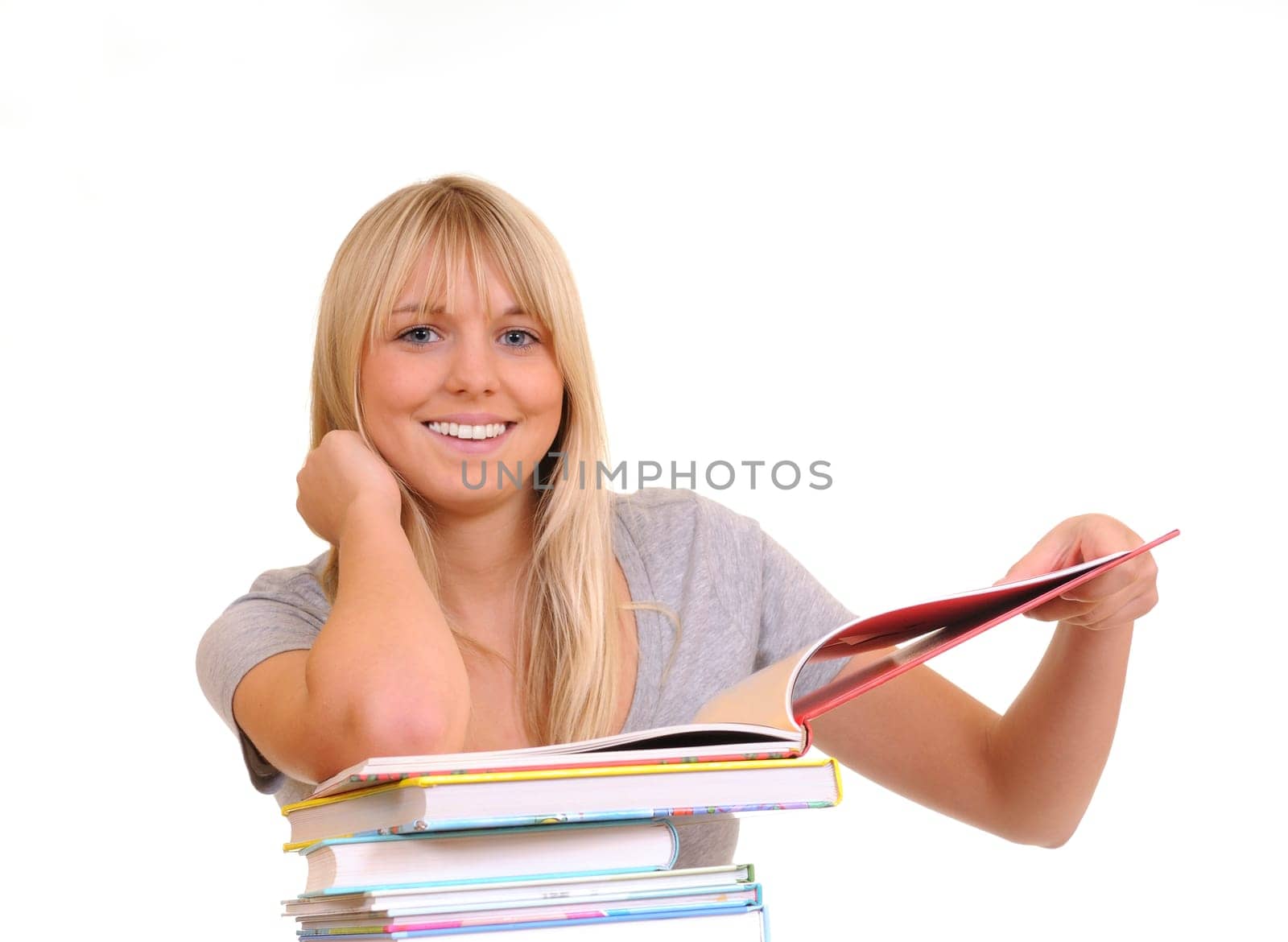 Laughing young woman with stack of books