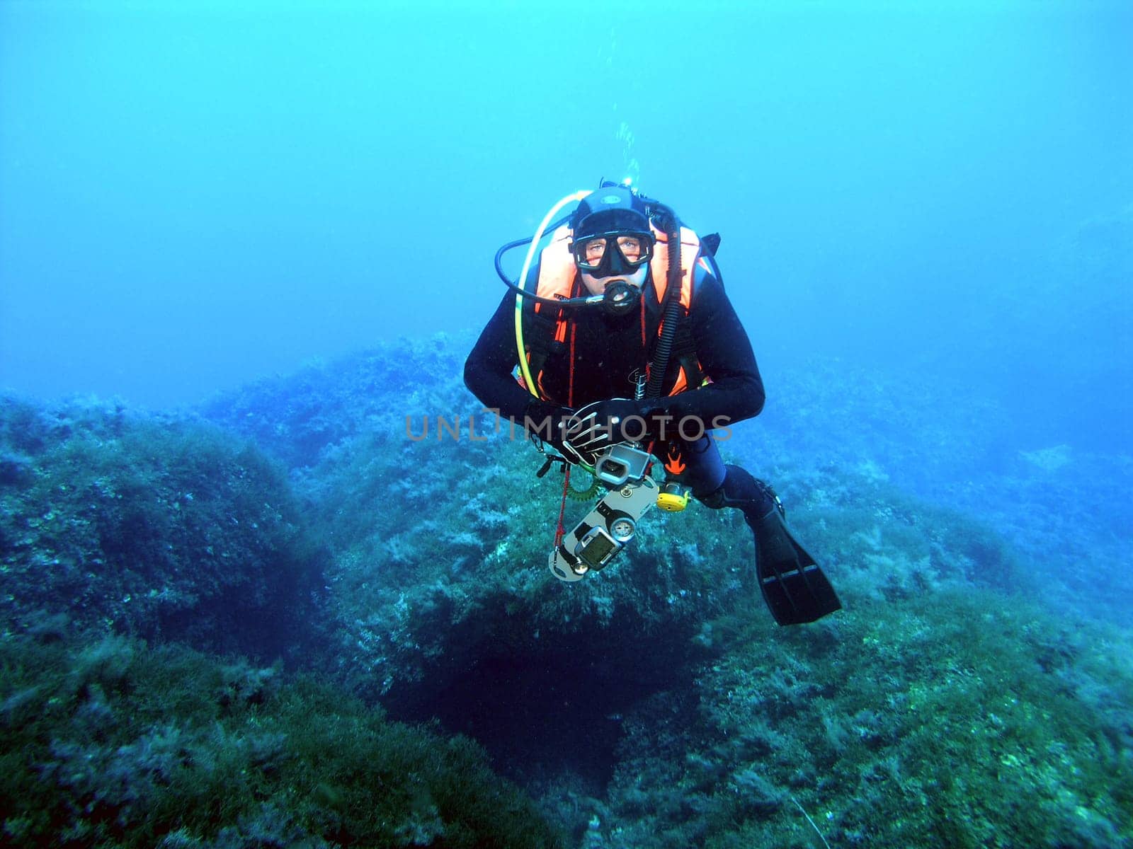 Diver in underwater rock landscape