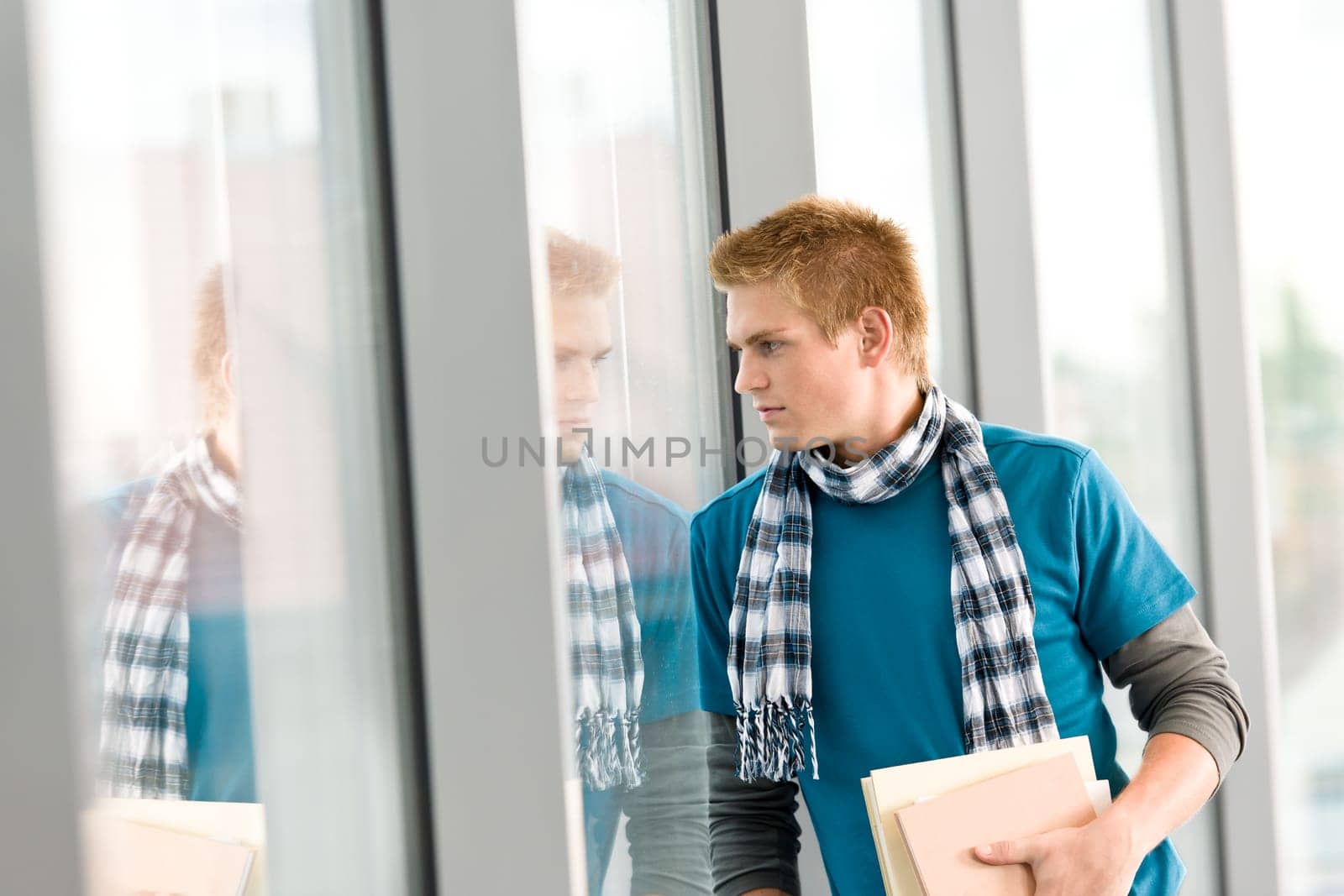 Male teenager holding book