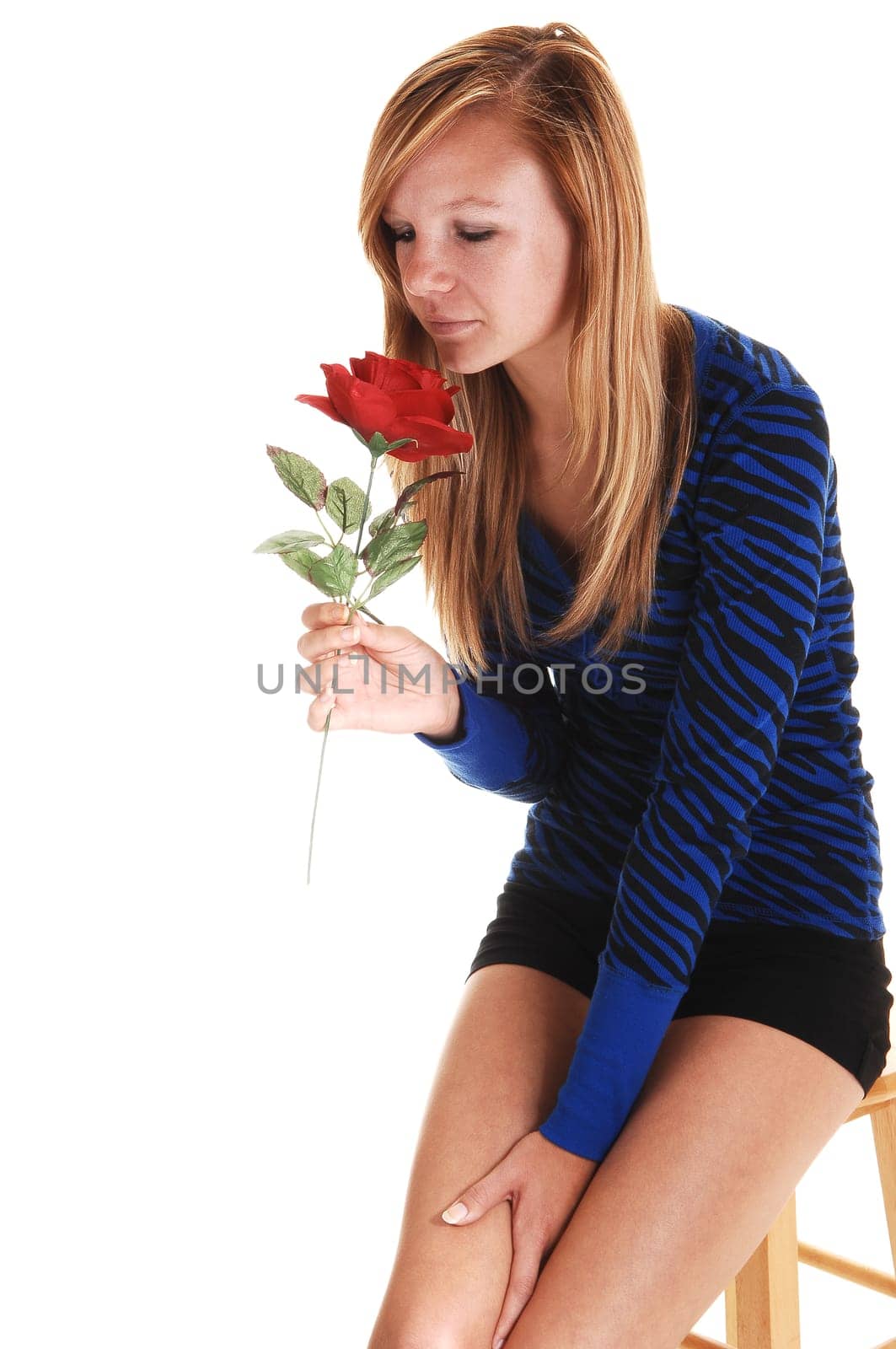 Girl smelling rose.