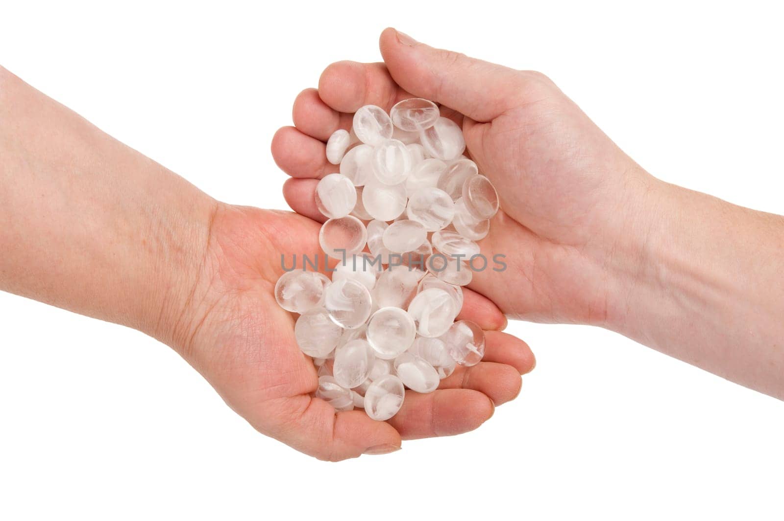 Pellucid stones in hands on white backgr