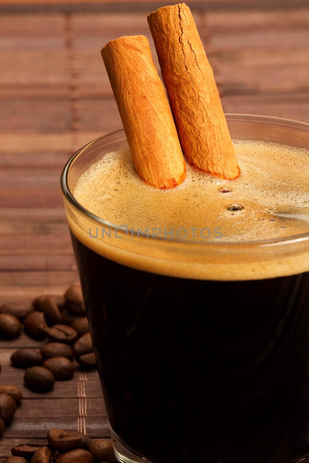 Cinnamon sticks in a glass with espresso