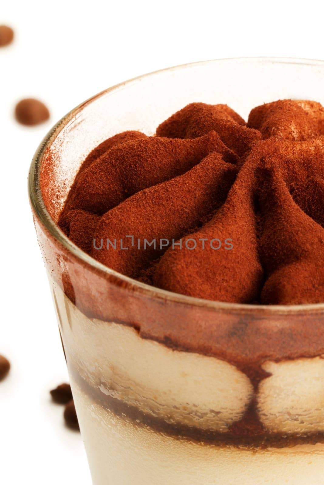 Tiramisu close-up in front of coffee beans