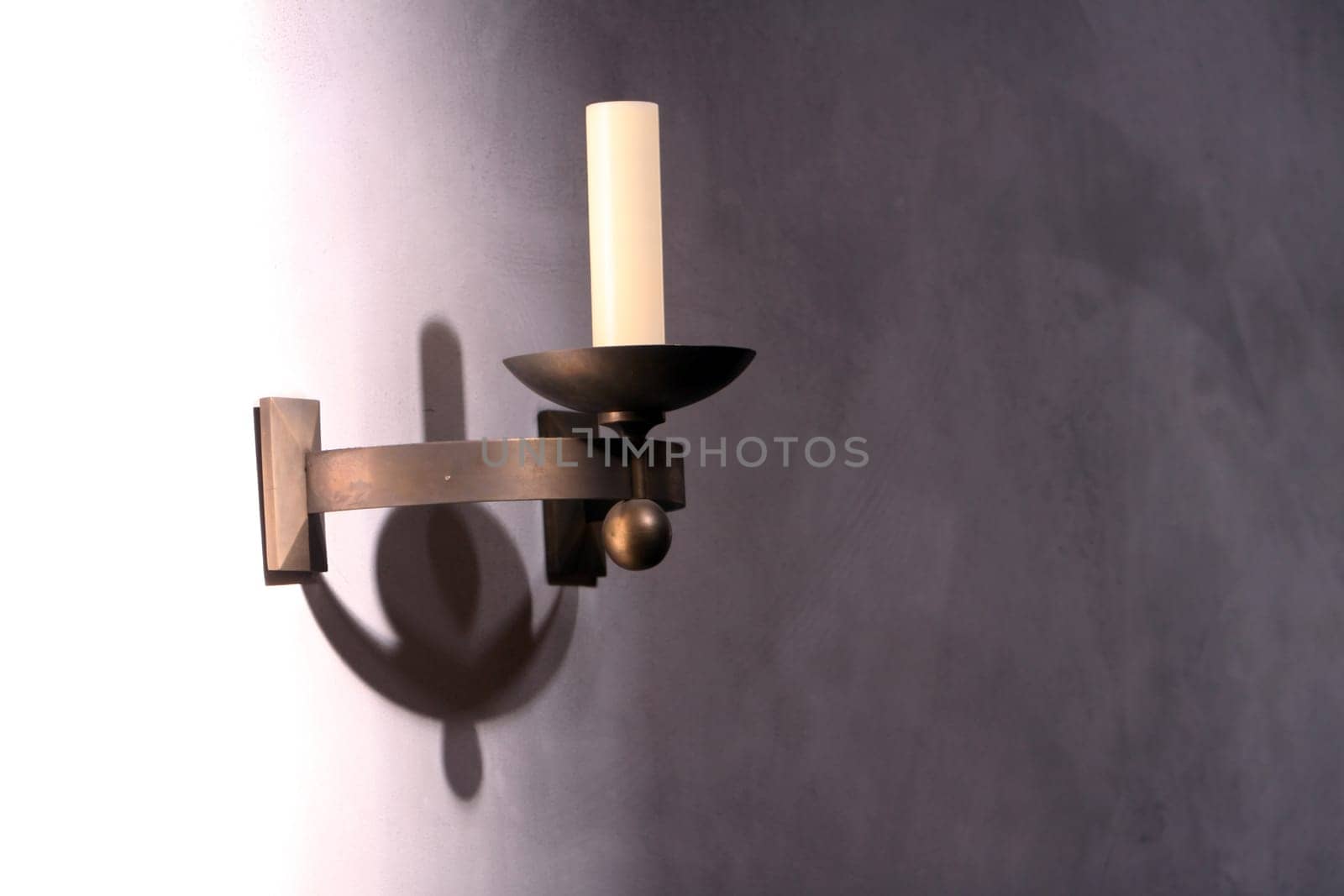 Candle in a wall bracket