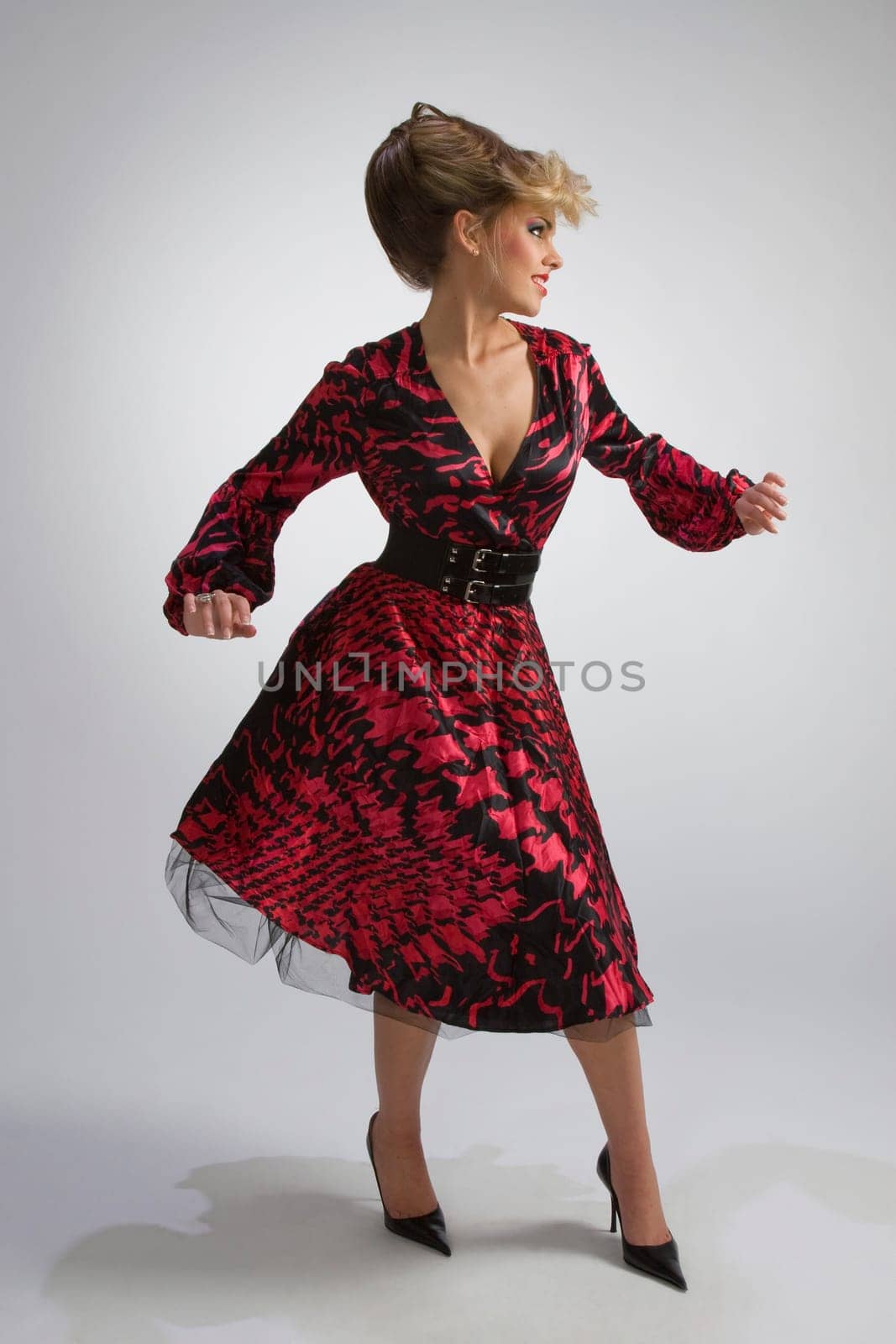 Attractive woman in spotted dress on gre