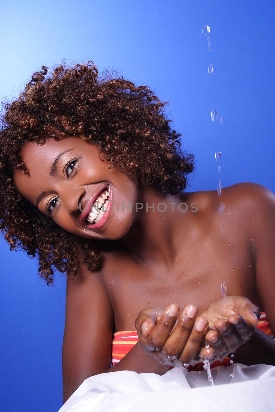 African woman playing with water