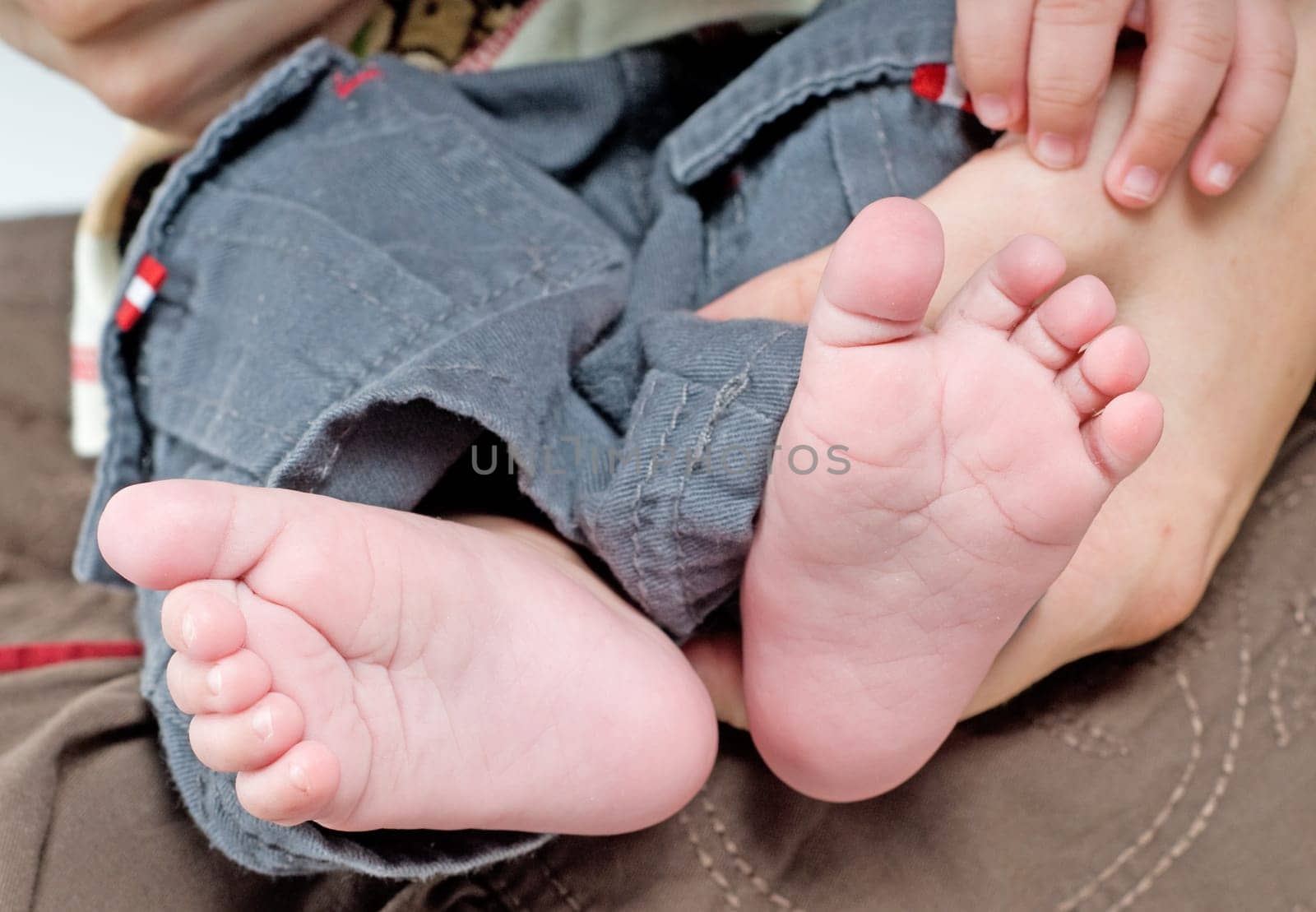 Newborn child and hands