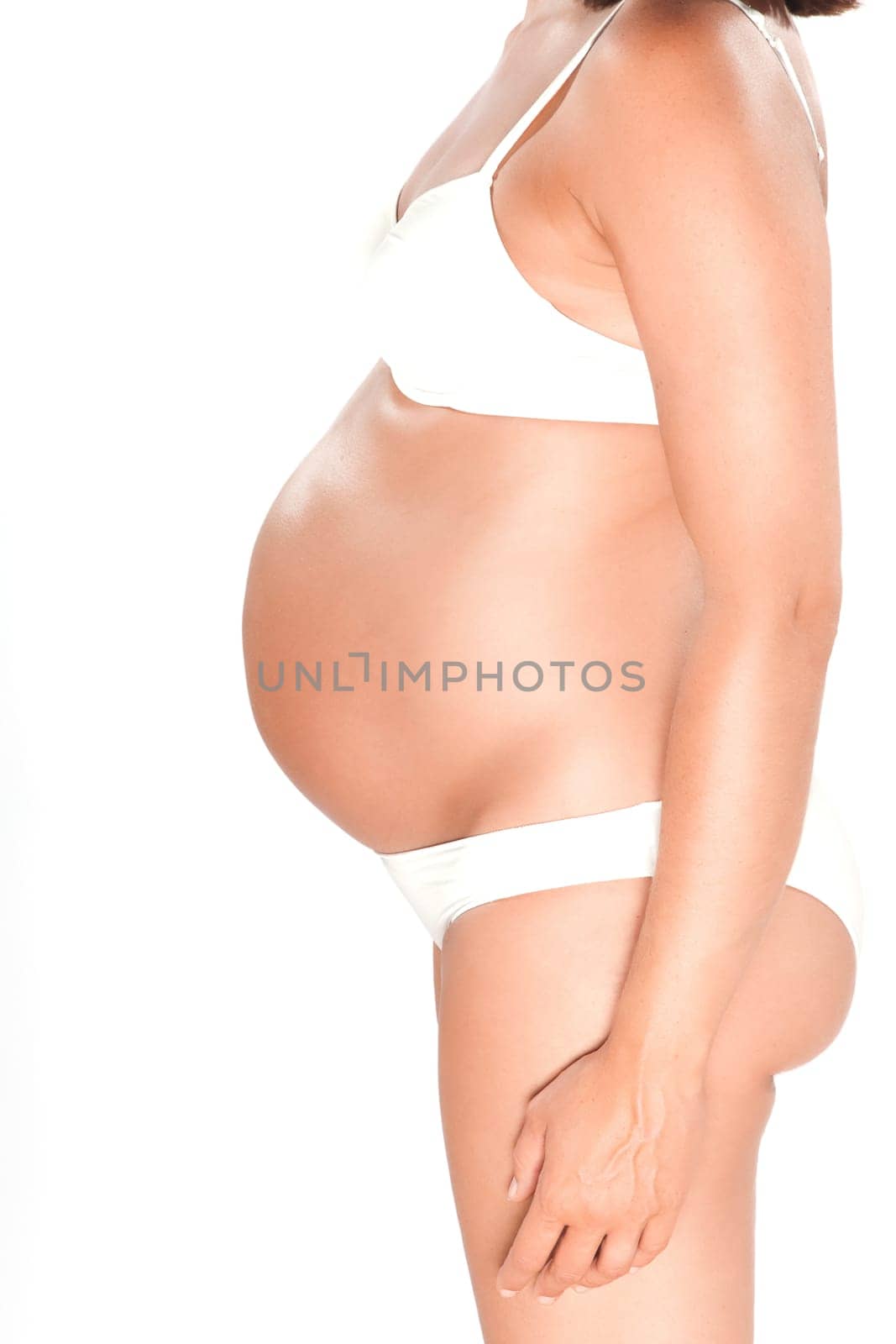 Pregnant woman belly detail profile side view