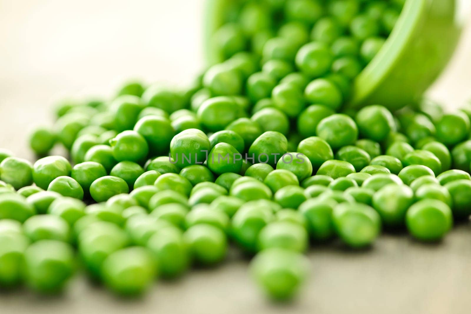 Spilled bowl of green peas